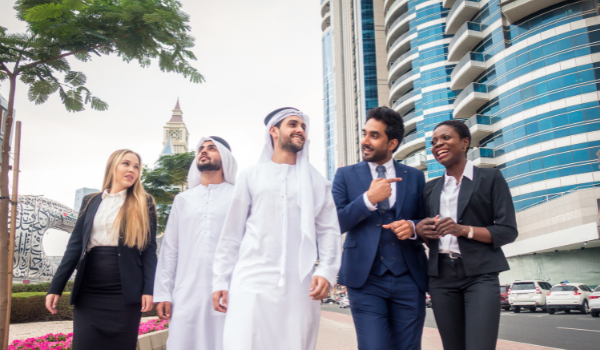 Diverse group of business professionals walking outdoors in Dubai